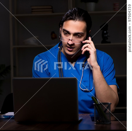 Young male doctor in the hospital at night Young male doctor in the hospital at night 97984359