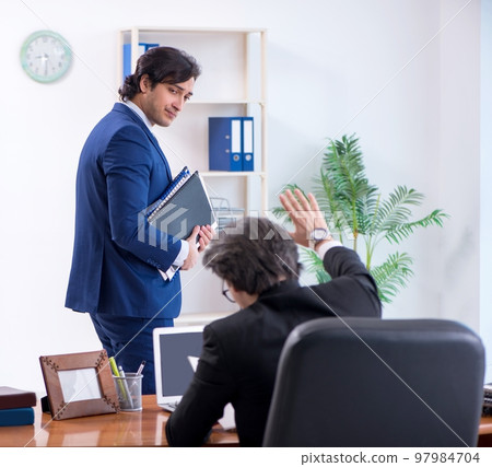 Boss and his male assistant working in the office 97984704