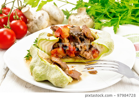 Patisson stuffed with liver and mushrooms in plate on wooden board 97984728