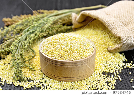 Millet in bowl on board 97984746