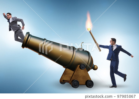 Concept of lay-off with businessman and cannon 97985867