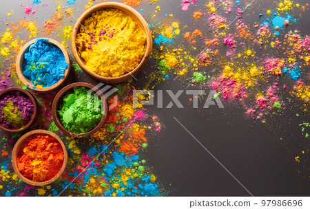 Happy Holi decoration, the indian festival.Top view of colorful holi powder on dark background. Happy Holi decoration, the indian festival.Top view of colorful holi powder on dark background. 97986696