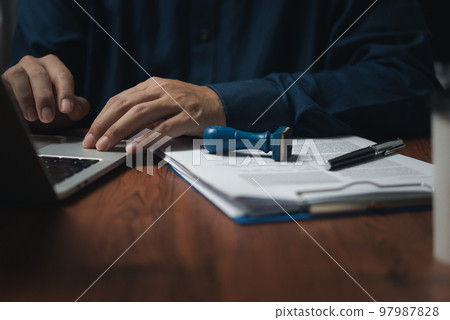 Businessman stamp rubber with approved stamp on document contract or paperwork lawyer. Businessman stamp rubber with approved stamp on document contract or paperwork lawyer. 97987828