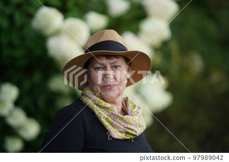 Social security for old people and pensioners, rich pensioner beautifully dressed and resting in a warm country 97989042