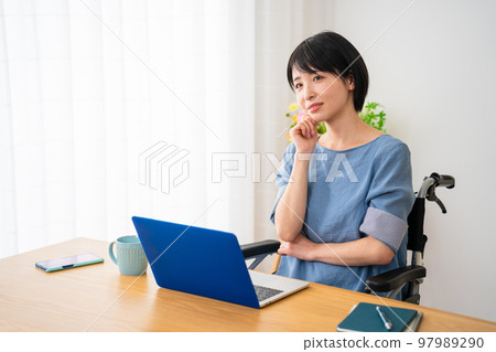 A young woman using a laptop in a wheelchair Image of a diverse society A young woman using a laptop in a wheelchair Image of a diverse society 97989290