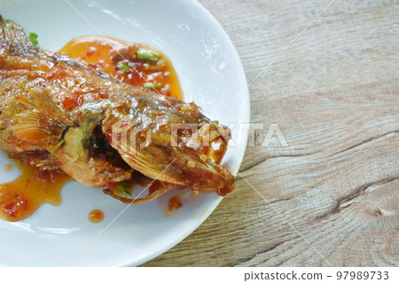 batter fried red grouper fish dressing sweet and spicy chili sauce on plate batter fried red grouper fish dressing sweet and spicy chili sauce on plate 97989733