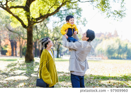 Image of a happy family spending time in the park Image of a happy family spending time in the park 97989960