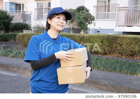 Courier female staff delivering packages Courier female staff delivering packages 97990196