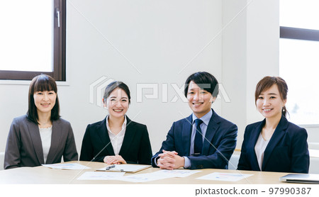 Male and female office workers, businessmen, businesswomen (smiles) in the office Male and female office workers, businessmen, businesswomen (smiles) in the office 97990387