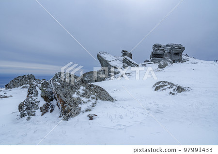 Rocks on the top of Mount Alenga. Southern Demerdzhi in snow and ice in spring. Crimea 97991433