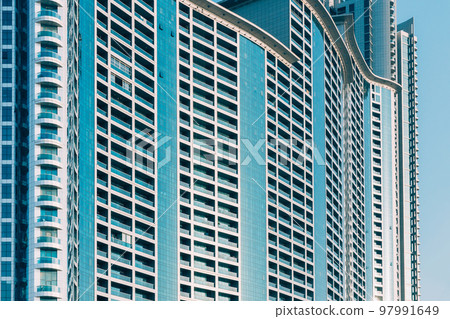 Wall With A Balcony Of New Empty Modern Multi-storey Residential Building House In Residential Area On Blue Sky. Close Up 97991649