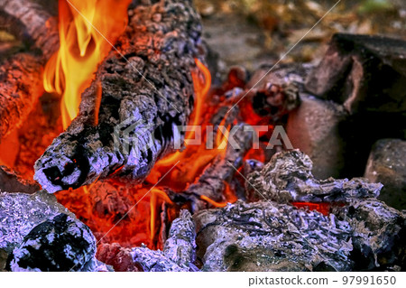 Campfire with fading flame and smoldering coals. Time for cooking meat 97991650