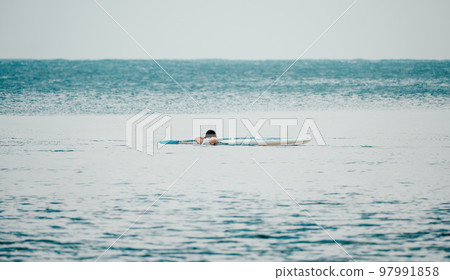 Sea man sup. Asian athlete man swimming in sea and paddleboarding at summer sunset. Healthy strong male enjoy outdoor active lifestyle and water sports on holiday vacation. Sea man sup. Asian athlete man swimming in sea and paddleboarding at summer sunset. Healthy strong male enjoy outdoor active lifestyle and water sports on holiday vacation. 97991858