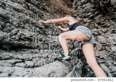 Sports Woman Climbing The Rock. Young woman With slim fit body c Sports Woman Climbing The Rock. Young woman With slim fit body c 97991862
