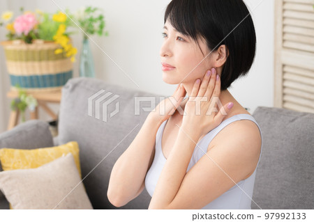 A young woman doing a self-massage of her neck Beauty image A young woman doing a self-massage of her neck Beauty image 97992133