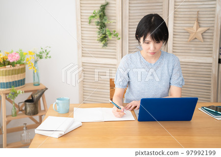 Young woman taking online course on laptop 97992199