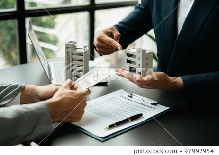 Signing a contract. Client and broker agent, lease agreement, successful deal and Young business sitting at the desk . Signing a contract. Client and broker agent, lease agreement, successful deal and Young business sitting at the desk . 97992954