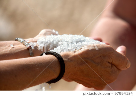 Dead Sea salt crystals heap in the hands Dead Sea salt crystals heap in the hands 97994184