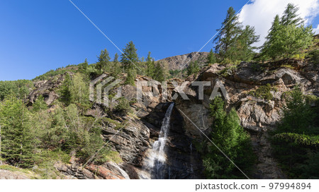 Lillaz waterfall (Cascate di Lillaz) splashes alpine water and breaks through crevice Lillaz waterfall (Cascate di Lillaz) splashes alpine water and breaks through crevice 97994894