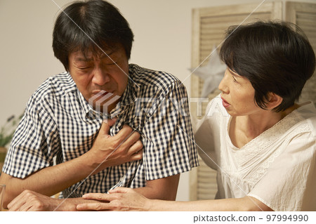 Middle-aged man with palpitations at home Middle-aged man with palpitations at home 97994990