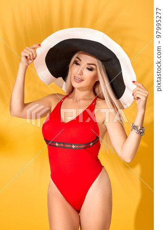Young sexy blonde woman with long straight hair posing in studio. Young sexy blonde woman with long straight hair posing in studio. 97995277