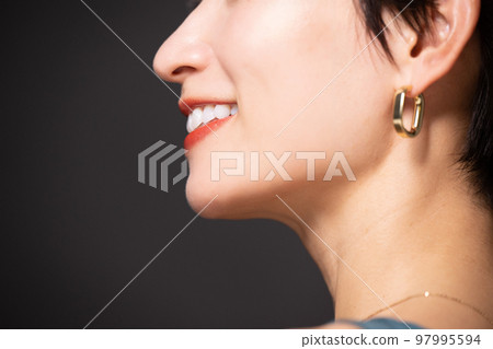 Close-up of the profile of a woman with a beautiful mouth that is easy to use for whitening and teeth correction Close-up of the profile of a woman with a beautiful mouth that is easy to use for whitening and teeth correction 97995594