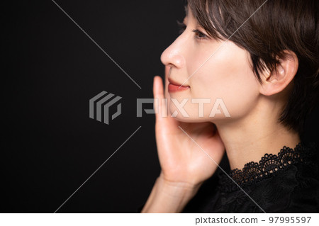 A woman who cares about her skin, black background, profile 97995597