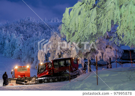 Illuminated ice-covered trees and snowmobiles in Yamagata Zao, Yamagata City, Yamagata Prefecture 97995878