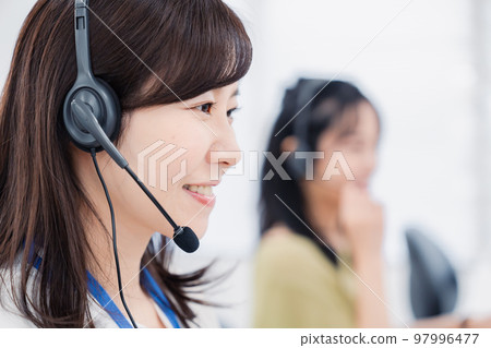 A woman serving customers at a call center A woman serving customers at a call center 97996477