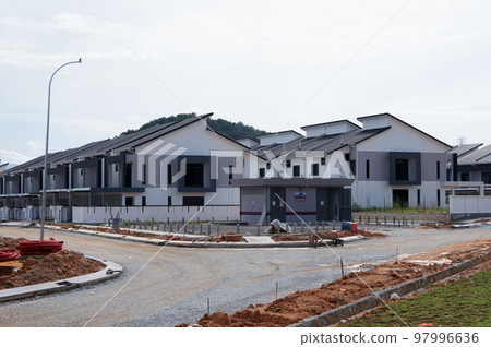 SELANGOR, MALAYSIA - JUNE 20, 2022: New double-story terrace house under construction in Malaysia. Have a wide porch. Utility facilities have also been built for future residents. 97996636