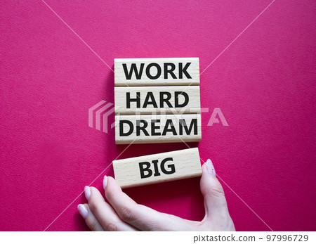 Work and dream symbol. Wooden blocks with words Work Hard Dream Big. Beautiful red background. Businessman hand. Business and Work Hard Dream Big concept. Copy space. 97996729