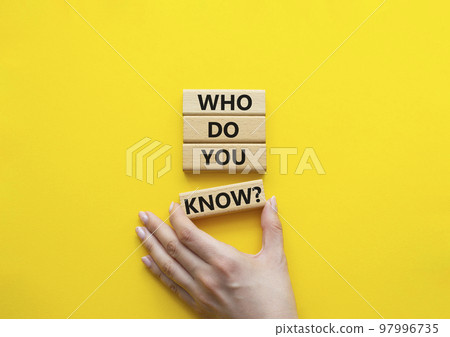 Who do you know symbol. Concept words Who do you know on wooden blocks. Beautiful yellow background. Businessman hand. Business and Who do you know concept. Copy space Who do you know symbol. Concept words Who do you know on wooden blocks. Beautiful yellow background. Businessman hand. Business and Who do you know concept. Copy space 97996735