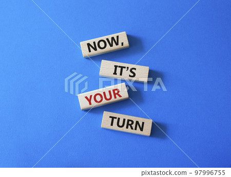 Now it's your turn symbol. Concept words Now it's your turn on wooden blocks. Beautiful blue background. Business and Now it's your turn me concept. Copy space 97996755