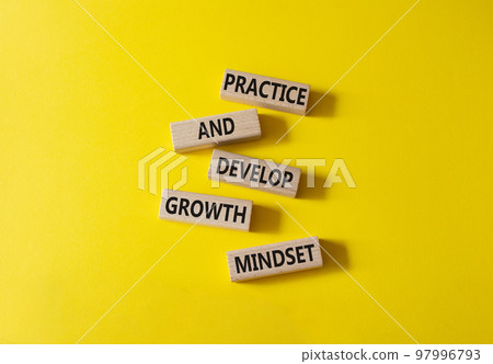 Practice and Develop growth mindset symbol. Wooden blocks with words Practice and Develop growth mindset. Beautiful yellow background. Business concept. Copy space 97996793