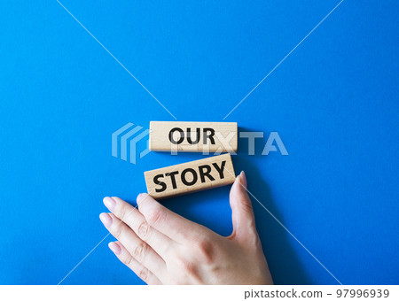 Our story symbol. Wooden blocks with words Our story Beautiful blue background. Businessman hand. Business and Our story concept. Copy space. Our story symbol. Wooden blocks with words Our story Beautiful blue background. Businessman hand. Business and Our story concept. Copy space. 97996939