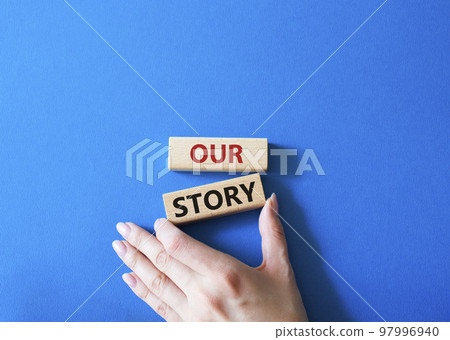 Our story symbol. Wooden blocks with words Our story Beautiful blue background. Businessman hand. Business and Our story concept. Copy space. Our story symbol. Wooden blocks with words Our story Beautiful blue background. Businessman hand. Business and Our story concept. Copy space. 97996940