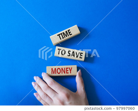 Time to save money symbol. Wooden blocks with words Time to save money. Businessman hand. Beautiful blue background. Business and Time to save money concept. Copy space. 97997060