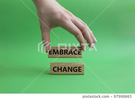 Embrace change symbol. Concept word Embrace change on wooden blocks. Beautiful green background. Businessman hand. Business and Embrace change concept. Copy space Embrace change symbol. Concept word Embrace change on wooden blocks. Beautiful green background. Businessman hand. Business and Embrace change concept. Copy space 97998665
