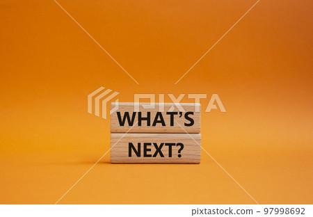What is next symbol. Concept word What is next on wooden blocks. Beautiful orange background. Business and What is next concept. Copy space What is next symbol. Concept word What is next on wooden blocks. Beautiful orange background. Business and What is next concept. Copy space 97998692