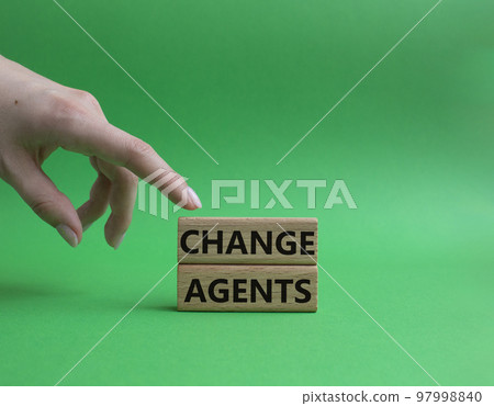 Change agents symbol. Concept word Change agents on wooden blocks. Beautiful green background. Businessman hand. Business and Change agents concept. Copy space 97998840