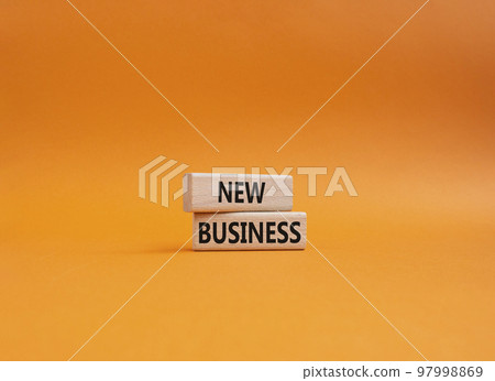 New business symbol. Concept words New business on wooden blocks. Beautiful orange background. Business and New business concept. Copy space. 97998869