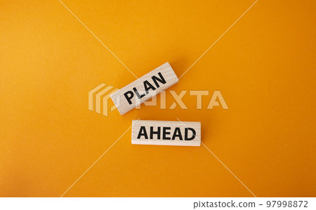 Plan ahead symbol. Wooden blocks with words Plan ahead. Beautiful orange background. Business and Plan ahead concept. Copy space. 97998872