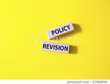 Policy revision symbol. Concept word Policy revision on wooden blocks. Beautiful yellow background. Business and Policy revision concept. Copy space Policy revision symbol. Concept word Policy revision on wooden blocks. Beautiful yellow background. Business and Policy revision concept. Copy space 97998890