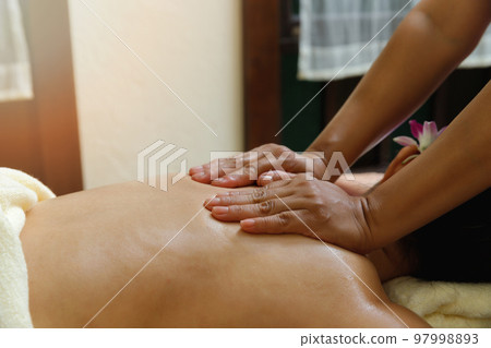 close-up masseur hands doing back massage in spa salon. Beauty treatment concept. close-up masseur hands doing back massage in spa salon. Beauty treatment concept. 97998893