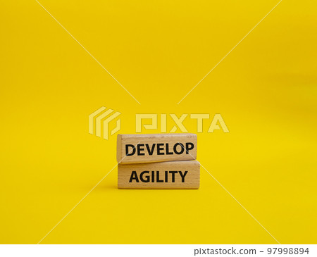 Develop agility symbol. Concept word Develop agility on wooden blocks. Beautiful yellow background. Business and Develop agility concept. Copy space Develop agility symbol. Concept word Develop agility on wooden blocks. Beautiful yellow background. Business and Develop agility concept. Copy space 97998894