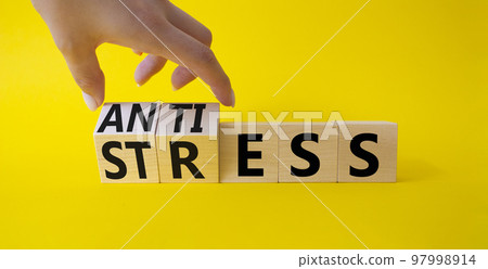 Antistress vs stress symbol. Concept words Antistress vs stress on wooden cubes. Beautiful yellow background. Doctor hand. Antistress vs stress concept. Copy space Antistress vs stress symbol. Concept words Antistress vs stress on wooden cubes. Beautiful yellow background. Doctor hand. Antistress vs stress concept. Copy space 97998914