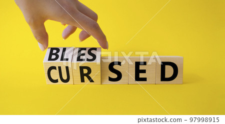 Blessed vs Cursed word symbol. Businessman Hand turns cubes with word Cursed and changes it to word Blessed. Beautiful yellow background. Religious and Blessed vs Cursed concept Blessed vs Cursed word symbol. Businessman Hand turns cubes with word Cursed and changes it to word Blessed. Beautiful yellow background. Religious and Blessed vs Cursed concept 97998915