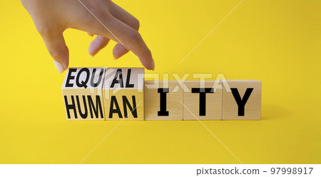 Equality and Humanity symbol. Businessman hand. Turned cubes with words Equality and Humanity. Beautiful yellow background. Business and Equality and Humanity concept. Copy space Equality and Humanity symbol. Businessman hand. Turned cubes with words Equality and Humanity. Beautiful yellow background. Business and Equality and Humanity concept. Copy space 97998917