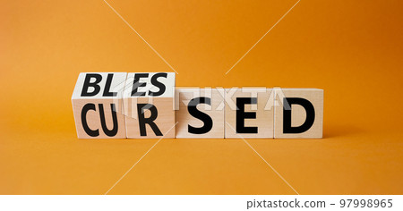 Blessed vs Cursed word symbol. Turned wooden cubes with words Cursed and Blessed. Beautiful orange background. Religious and Blessed vs Cursed concept Blessed vs Cursed word symbol. Turned wooden cubes with words Cursed and Blessed. Beautiful orange background. Religious and Blessed vs Cursed concept 97998965