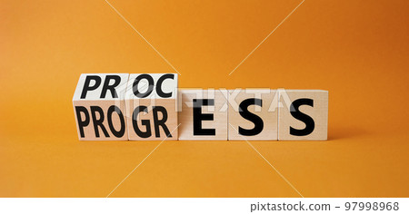 Process and Progress symbol. Turned wooden cubes with words Process and Progress. Beautiful orange background. Business and Process and Progress concept. Copy space Process and Progress symbol. Turned wooden cubes with words Process and Progress. Beautiful orange background. Business and Process and Progress concept. Copy space 97998968